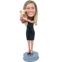 female holding a trophy